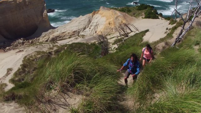 Couple hiking on sand dunes at beach