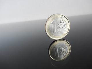 Single Euro coins on grey background