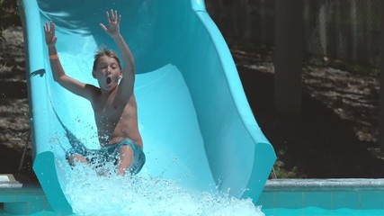 Boy going down waterslide in super slow motion