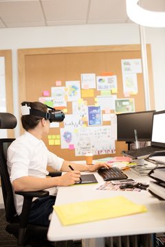Creative businessman using digitizer and VR glasses 