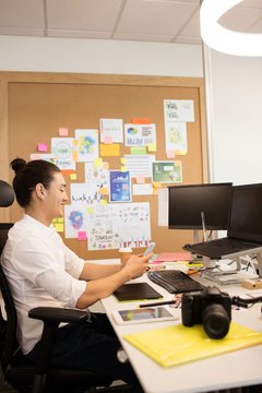 Designer using mobile phone in creative office