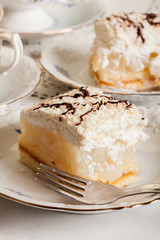 Fresh sweet apple cake with whipped cream served with cup of tea
