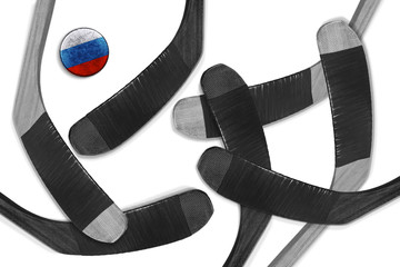 Russian puck and hockey sticks