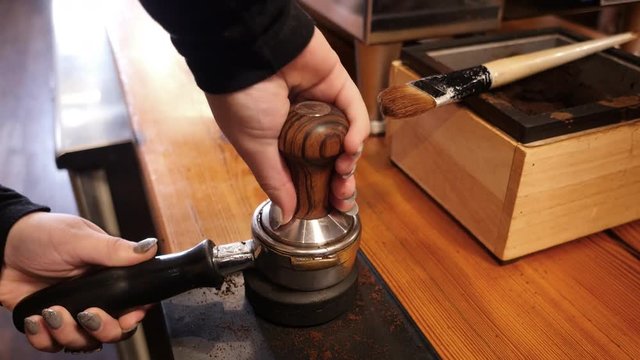 Woman making coffee at cafe