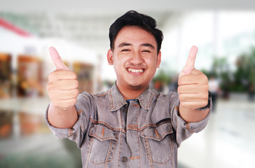 Young Asian Guy Showing Two Thumbs Up