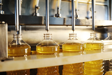 Sunflower oil production plant. Bottling line of vegetable oil in bottles