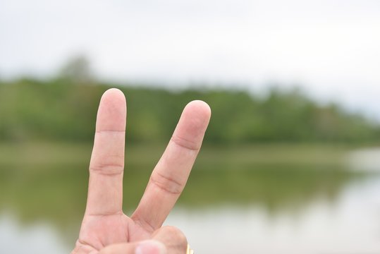 Hand with two fingers up in the peace or victory symbol.