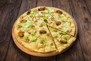 Italian seafood pizza at wood background