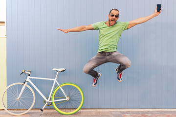 Outdoor portrait of handsome jumping.