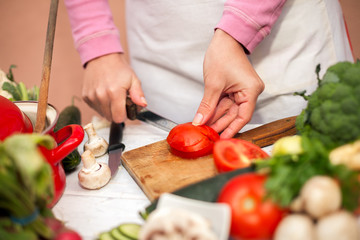 Woman slicing tomato