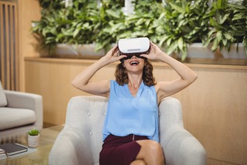 Happy executive using virtual reality headset