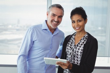 Portrait of executives using digital tablet