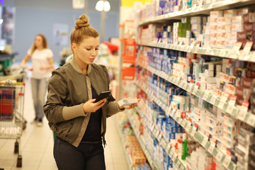 Woman choosing a dairy products at supermarket 