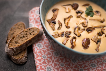 Creamy Mushroom Soup in Bowl on Stone Background. Homemade Mushrooms Pottage Puree.