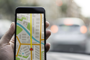 GPS Navigation on Mobile Phone Device and Transportation Concept. Male Hand Using Navigation System...