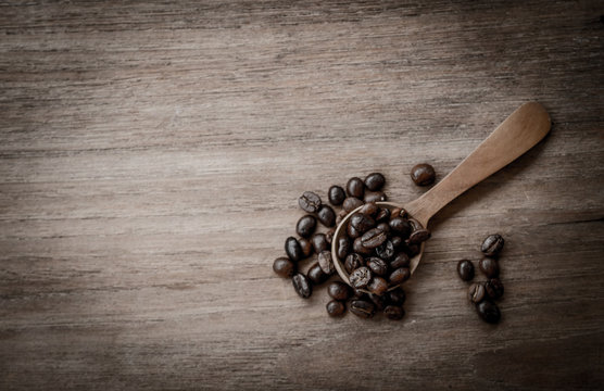 coffee beans isolated on wood background.