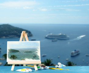 Easel with a watercolor painting bay of Monaco. Abstract image with place for text.