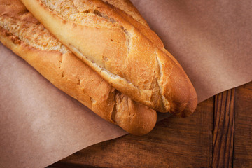 Crispy baguettes on wrapping paper