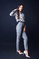 Studio photo of young woman on black background