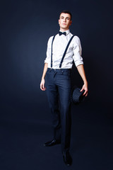 Fashion photo of young model man on black background. Boy posing. Studio photo.
