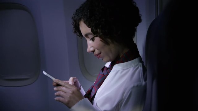 Flight Attendant Using Cell Phone At Night