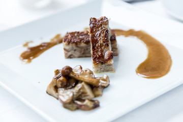 Delicious meatloaf of modern kitchen at low temperature with mushroom sauce.