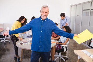 Fototapeta premium Portrait of businessman with arms outstretched 