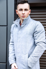 Fashion photo of young model man on street. Boy posing.