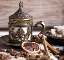 Turkish coffee with delight and traditional copper serving set on wooden