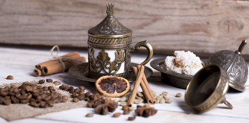 Turkish coffee with delight and traditional copper serving set on wooden