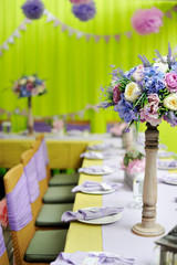 holiday table with a vase from fresh flowers
