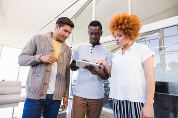 Business people discussing over digital tablet