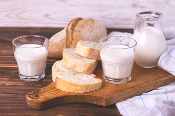 Sliced wheat bread, glass of fresh milk