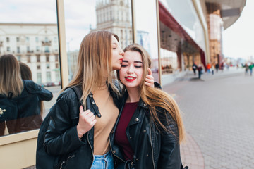 Two friends meeting in the street of the city and hugging . friendship, happiness concept . Couple of woman