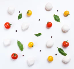 Foto op Plexiglas Red and yellow cherry tomatoes, cherry mozzarella,fresh basil, black pepper on white background, top pattern © Hanna