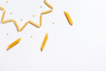 Fusilli, penne, stars shaped pasta pattern is laid out on a white background. Empty space for text or inscription.