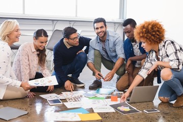 Creative business team discussing over documents