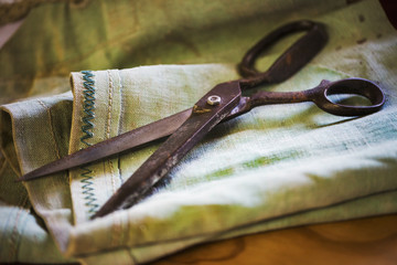 Close up of a pair of rusty scissors in a sailmaker's workshop.