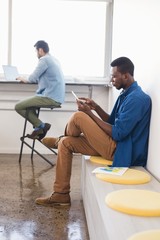 Fototapeta premium Creative businessman using mobile phone at office