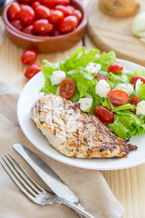 Grilled Chicken Breast with Fresh Vegetables on Light Wooden Background, Selective Focus