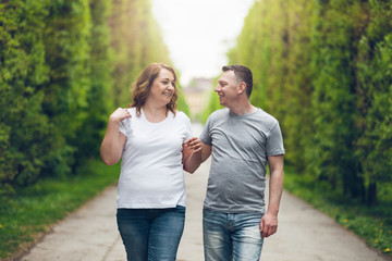 Happy loving couple on a romantic walk outdoors in park