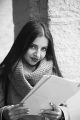 Young beautiful business woman with documents in her hands outdoors. (Business, work, contract, success concept)