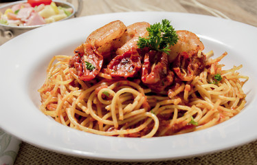 Seafood pasta Spaghetti with Clams, Prawns, Seafood Cocktail in set have salad on wood table