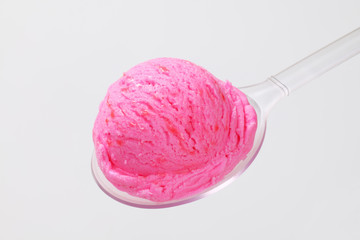 Scoop of pink ice cream on spoon
