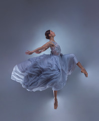Fototapeta premium The beautiful ballerina dancing in blue long dress 