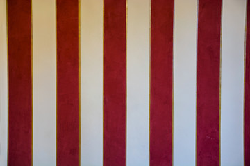 Fototapeta premium Vintage red and white stripes decorated wall in old house