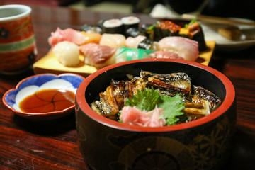 sea eel rice on Japanese bowl and sushi plate in the background