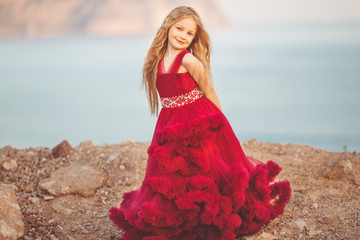 Child girl on the top of mountain with sea view