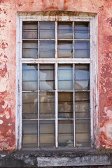 old damaged window of the facade of the building
