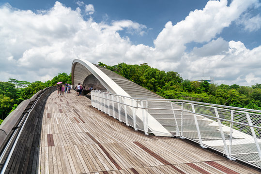 Bridge imitating wave. Wooden walkway leading to park, Singapore